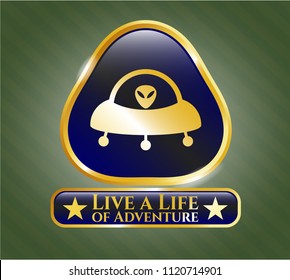  Gold shiny badge with ufo with aline inside icon and Live a Life of Adventure text inside