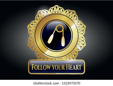  Gold shiny emblem with hand gripper icon and Follow your Heart text inside