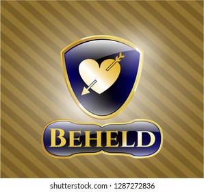  Gold shiny emblem with heart with arrow icon and Beheld text inside