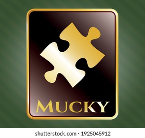 Gold shiny emblem with jigsaw puzzle piece icon and Mucky text inside