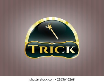 Emblema dorado brillante con icono de palo mágico y texto de truco dentro