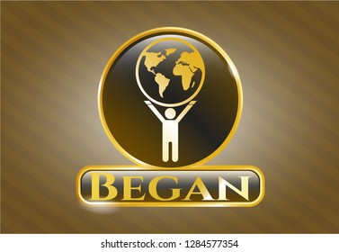  Gold shiny emblem with man lifting world icon and Began text inside