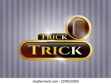 Emblema dorado brillante con icono del libro de notas y texto de truco dentro