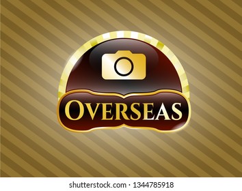  Gold shiny emblem with photo camera icon and Overseas text inside