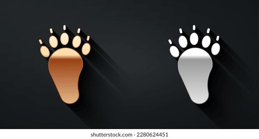 Gold and silver Bear paw footprint icon isolated on black background. Long shadow style. Vector