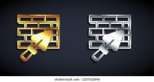 Gold and silver Brick wall with trowel icon isolated on black background. Long shadow style. Vector