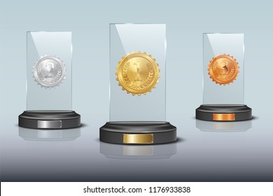 Gold, silver and bronze glass trophy awards isolated on blue background. Vector design elements