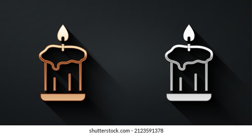 Gold and silver Burning candle in candlestick icon isolated on black background. Old fashioned lit candle. Cylindrical candle stick with burning flame. Long shadow style. Vector