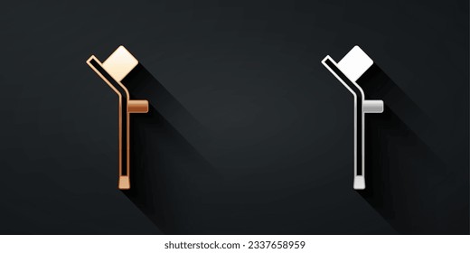 Gold and silver Crutch or crutches icon isolated on black background. Equipment for rehabilitation of people with diseases of musculoskeletal system. Long shadow style. Vector