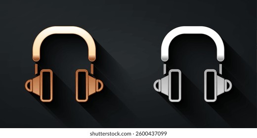 Gold and silver Headphones icon isolated on black background. Earphones. Concept for listening to music, service, communication and operator. Long shadow style. Vector