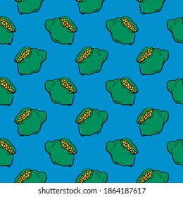Oro en una pequeña bolsa verde, sin costuras sobre fondo azul.