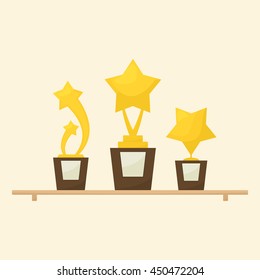 Gold star trophies awards on shelf