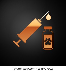 Gold Syringe with pet vaccine icon isolated on black background. Dog or cat paw print. Vector Illustration