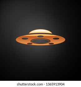 Gold UFO flying spaceship icon isolated on black background. Flying saucer. Alien space ship. Futuristic unknown flying object. Vector Illustration