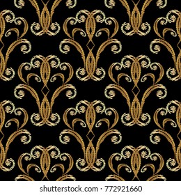 Gold vector embroidery Damask  seamless pattern. Tapestry vintage background. Antique golden floral ornaments in baroque style. Ornate damask gold flowers, scroll leaves. Embroidered grunge texture