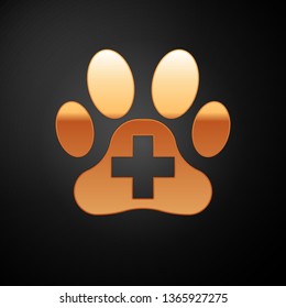 Gold Veterinary clinic symbol icon isolated on black background. Cross hospital sign. A stylized paw print dog or cat. Pet First Aid sign. Vector Illustration
