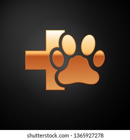 Gold Veterinary clinic symbol icon isolated on black background. Cross hospital sign. A stylized paw print dog or cat. Pet First Aid sign. Vector Illustration