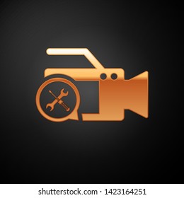 Gold Video camera with screwdriver and wrench icon isolated on black background. Adjusting, service, setting, maintenance, repair, fixing.  Vector Illustration