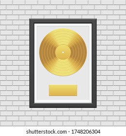 Gold Vinyl Record With Black Frame On White Brick Wall