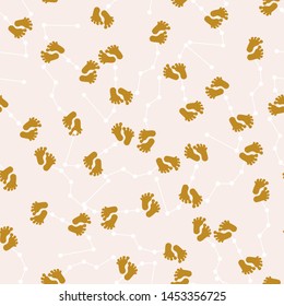 Golden baby feet and celestial elements in a seamless pattern design, that can be used both on the web or in print for surface design