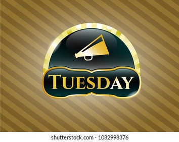   Golden badge with megaphone icon and Tuesday text inside