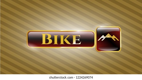  Golden badge with mountain icon and Bike text inside