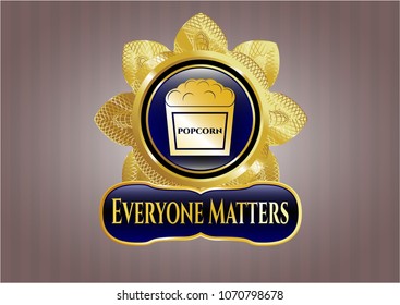  Golden badge with popcorn icon and Everyone Matters text inside