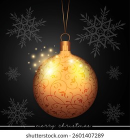 A golden bauble with a swirling pattern design, set against a black festive scene of scattered snowflakes.