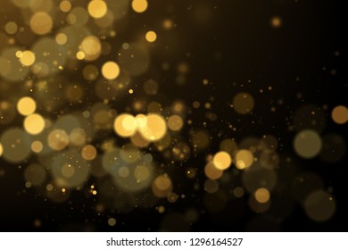 Golden bokeh lights on black. Glowing particles abstract background.
