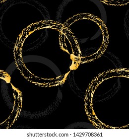 Golden brush stroke circle seamless pattern. Vector hand drawn texture illustration, gold ornament on a black background. Stylized chain.