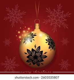 A golden Christmas sphere with a black flower pattern set against a red festive background.