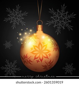 A golden Christmas sphere with a flower pattern set against a black background with snowflakes.