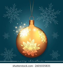 A golden Christmas sphere with a white flower pattern set against a blue festive background.