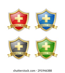 Golden clinically tested symbol shields with cross and ribbon on white background