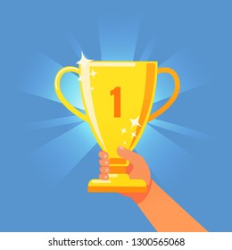 The golden cup glows. Grand Prize. Reaching the goal. Hand holding a cup.