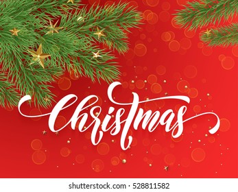 Golden decoration ornaments of stars and Christmas ball on decorative red background with Christmas tree branches. Merry Christmas text calligraphy lettering 