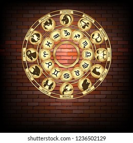 Golden disk of zodiac signs on a brick wall