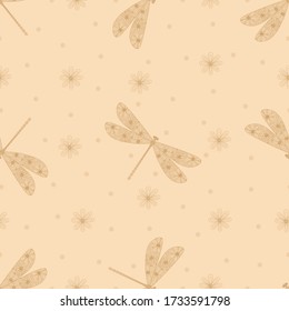 Golden dragonfly silhouette seamless pattern. Hand drawn doodle. Linear style. Decorative insects. Vector illustration on a beige background. For fabrics, wrapping paper.