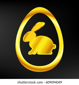 Golden Easter Bunny in a gold egg on dark background