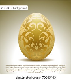 Golden egg with floral decoration.