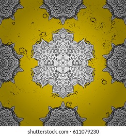 Golden element on yellow background. yellow floral ornament in baroque style. Damask pattern repeating background.