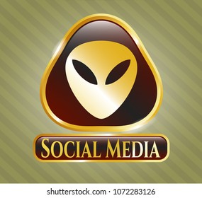   Golden emblem with alien icon and Social Media text inside