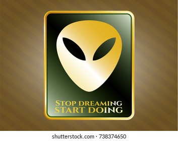 Golden emblem with alien icon and Stop dreaming start doing text inside