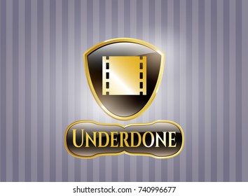  Golden emblem or badge with film icon and Underdone text inside
