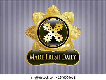  Golden emblem or badge with mechanism icon and Made Fresh Daily text inside