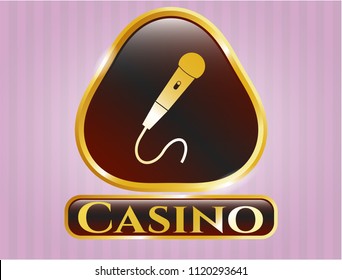  Golden emblem or badge with microphone icon and Casino text inside