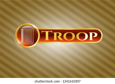  Golden emblem or badge with note book icon and Troop text inside