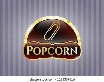  Golden emblem or badge with paper clip icon and Popcorn text inside