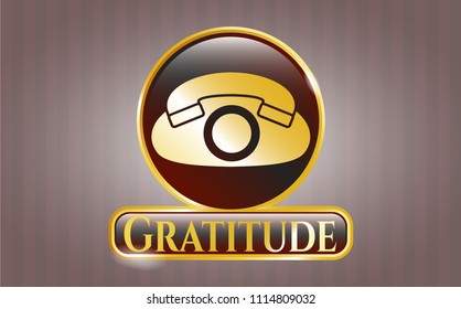  Golden emblem or badge with phone icon and Gratitude text inside