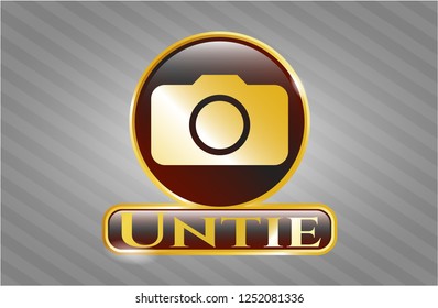  Golden emblem or badge with photo camera icon and Untie text inside